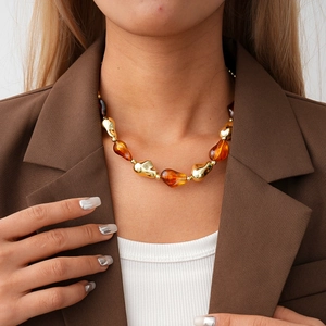 Acrylic amber and gold irregular chunky beaded statement necklace on female model