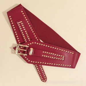 Close-up of wide burgundy waist belt with golden spherical rivets and square buckle