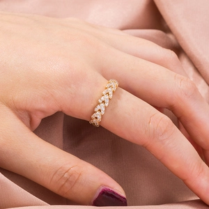 Elegant gold leaf ring with micro-paved cubic zirconia and pearls on pink satin