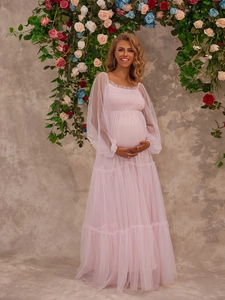 Elegant pink tulle maternity gown featuring sheer long sleeves and tiered mesh skirt