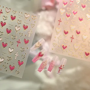 Macro detail of M-1033 gold-stamped heart and cross nail art stickers on long pink nails