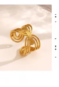 Detailed close-up of golden multi-layered wavy ring with modern minimalist flowing design