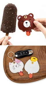 Détail de couvre-clés en cuir en forme d'animaux avec design d'ours, de chat et bâtonnet