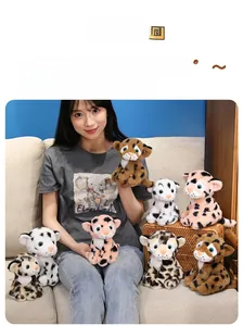 Close-up of assorted soft plush leopard dolls in various colors held by a model
