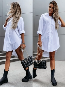Detail view of the white long-sleeved shirt dress with irregular high-low hem and pockets