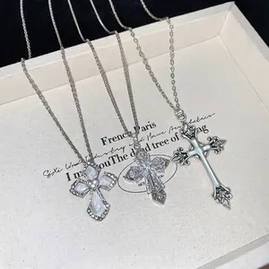 Three elegant cross necklaces with mother of pearl and cubic zirconia in silver