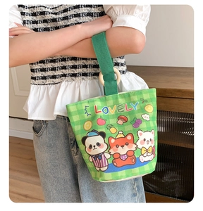 Detailed shot of canvas bucket bag with cartoon prints and a natural wooden ring handle