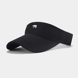 Detail of bear embroidery on black sun visor hat with premium stitching and texture