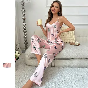 Pink satin two-piece pajama set with butterfly print featuring cami top and long pants