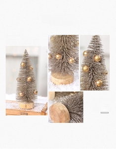 Close-up of champagne gold mini sisal Christmas tree with wood base and gold ornaments