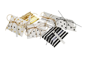 Detail showing pillow candy boxes with gold stripes and polka dots for wedding favors