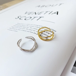 Macro detail of S925 sterling silver minimalist double cross open rings in silver and gold