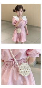 Detail showing hand-woven white pearl crossbody bag for kids with pink dress outfit