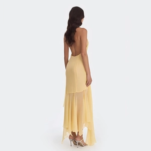 Detailed back view of a yellow backless maxi dress with irregular chiffon hemline