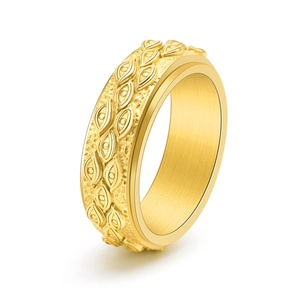 Macro shot of gold stainless steel spinning ring with embossed evil eye vintage patterns