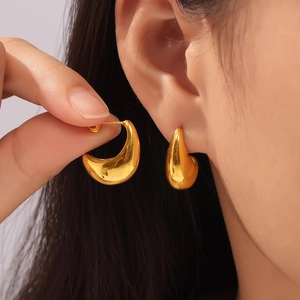 Polished 18k gold plated hollow crescent stud earrings worn by model for elegant style