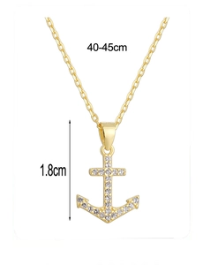 Detailed view of gold anchor pendant with white cubic zirconia and size dimensions