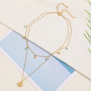 Double-layered gold shell necklace with light green beads and shell charms for summer