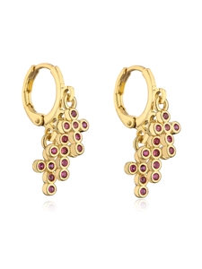 Detail view of gold earrings with pink gemstone clusters on a clean white background