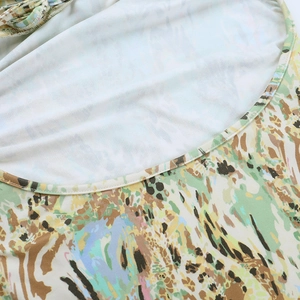 Detailed close-up of single-needle edging and colorful abstract floral print on fabric