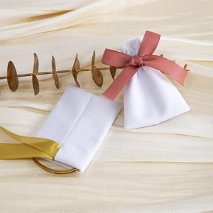 White velvet drawstring jewelry bags with elegant pink and gold ribbon bow details