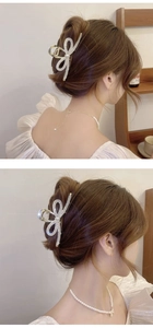 Detailed view of hair claw clip with rhinestones and pearls on elegant bun hairstyle