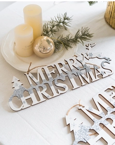 Detail of Merry Christmas wooden hanging plaque with silver glitter and rustic twine