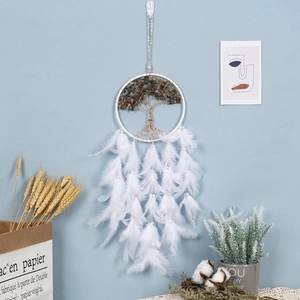 Detail of life tree dream catcher with natural stone chips and white feathers hanging