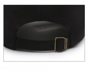 Detail of adjustable metal buckle and black twill fabric strap on a baseball cap