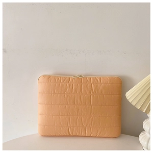 Quilted laptop sleeve in orange with dual zippers and soft protective horizontal padding