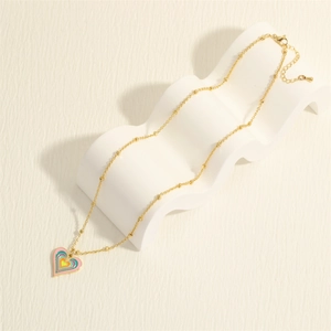 Golden heart necklace with rainbow enamel pendant on an elegant bead chain display