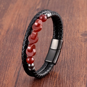 Close-up of double-layer woven leather bracelet with red agate beads and metal clasp