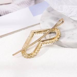 Elegant gold alloy heart-shaped hair clip with sparkling rhinestones on white background