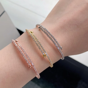 Three-color S925 silver layered bangles with micro-pave cubic zirconia on a wrist