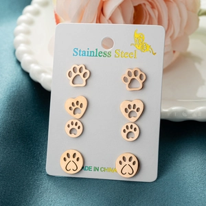 Set of 4 pairs of gold stainless steel cat paw stud earrings on an elegant display card