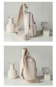 Detailed side and back view of a beige pebble leather crossbody bag with silver zippers