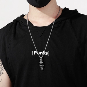 Close-up of vintage steel double skull pendant necklace worn with a black punk hoodie
