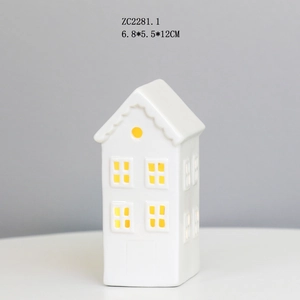 Macro detail of a white ceramic house LED light with hollow windows and 6.8x5.5x12cm size