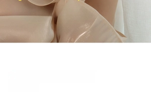 Detailed view of champagne satin fabric with soft pearl luster and smooth texture finish