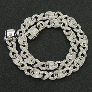 Macro view of iced out silver Cuban link chain necklace with pavé cubic zirconia
