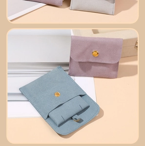 Close-up of microfiber jewelry pouches in lavender and blue with metal snap buttons