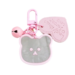 Pink cartoon bear mirror keychain with heart tag and bell on a clean white background