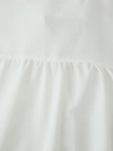 Detailed close-up of white breathable linen-cotton fabric with fine pleated stitching details