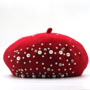Close-up of red wool beret featuring elegant white pearls and sparkling rhinestones