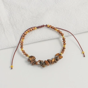 Detail of handmade bohemian bracelet with natural brown stones and adjustable cord