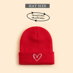 Detailed size chart for red knit beanie with embroidered heart, fits 56-58cm head circumference