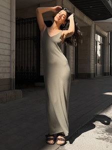 Detail of olive green knitted camisole maxi dress with elegant V-neck and slim fit texture