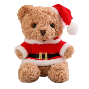 Brown Christmas teddy bear in a red Santa outfit and hat, white background view