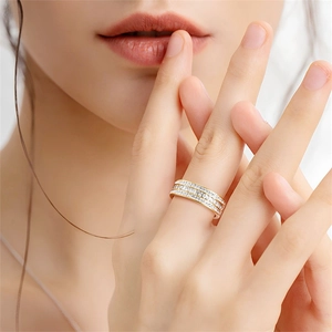 Close-up of elegant gold triple-row micro-pave zirconia ring on woman's finger