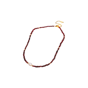 Titanium steel necklace with garnet-style red beads and a single freshwater pearl accent